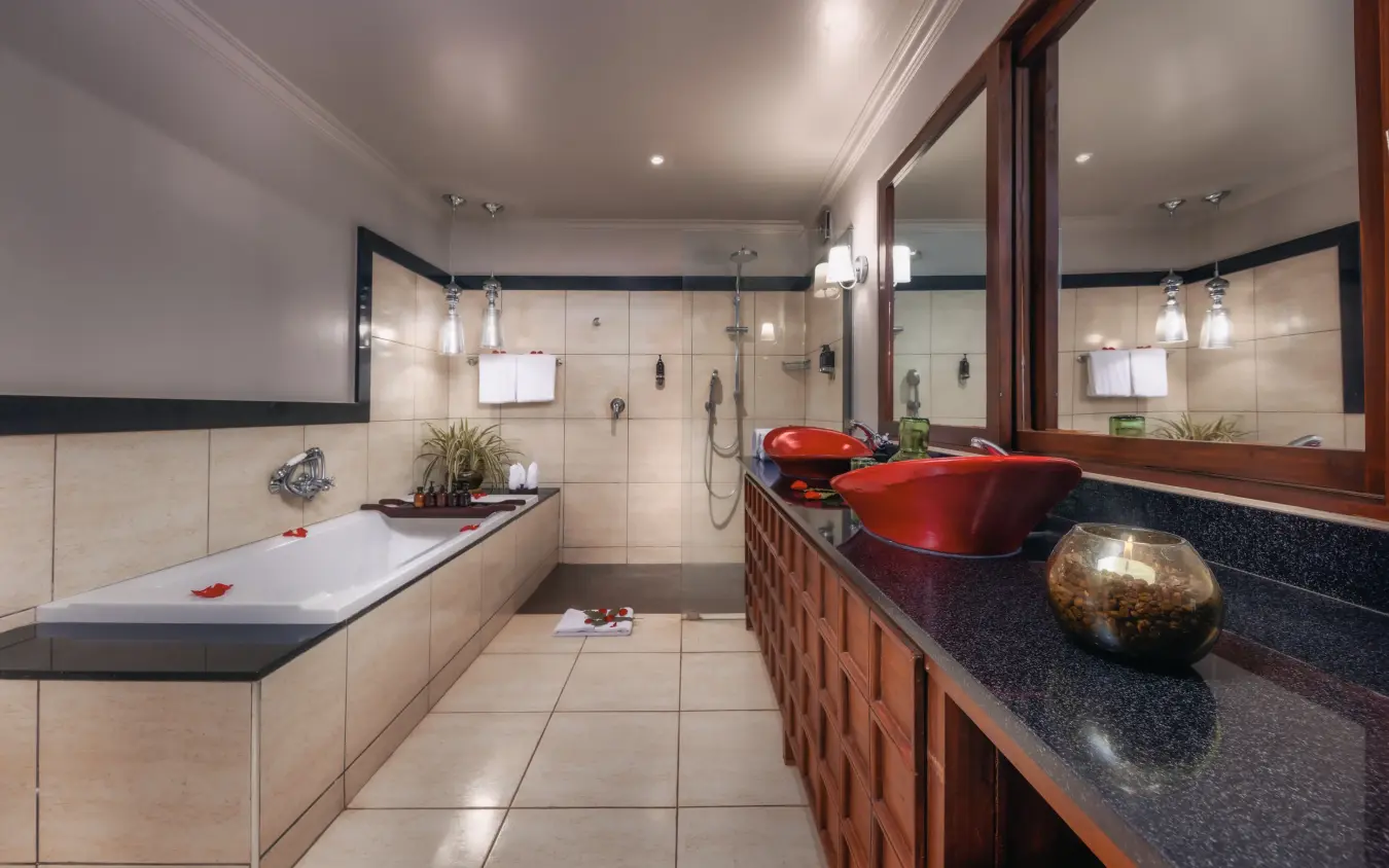 Luxury bathroom with sunken tub and double vanity with dark countertops, Arusha Coffee Lodge, Arusha, Tanzania