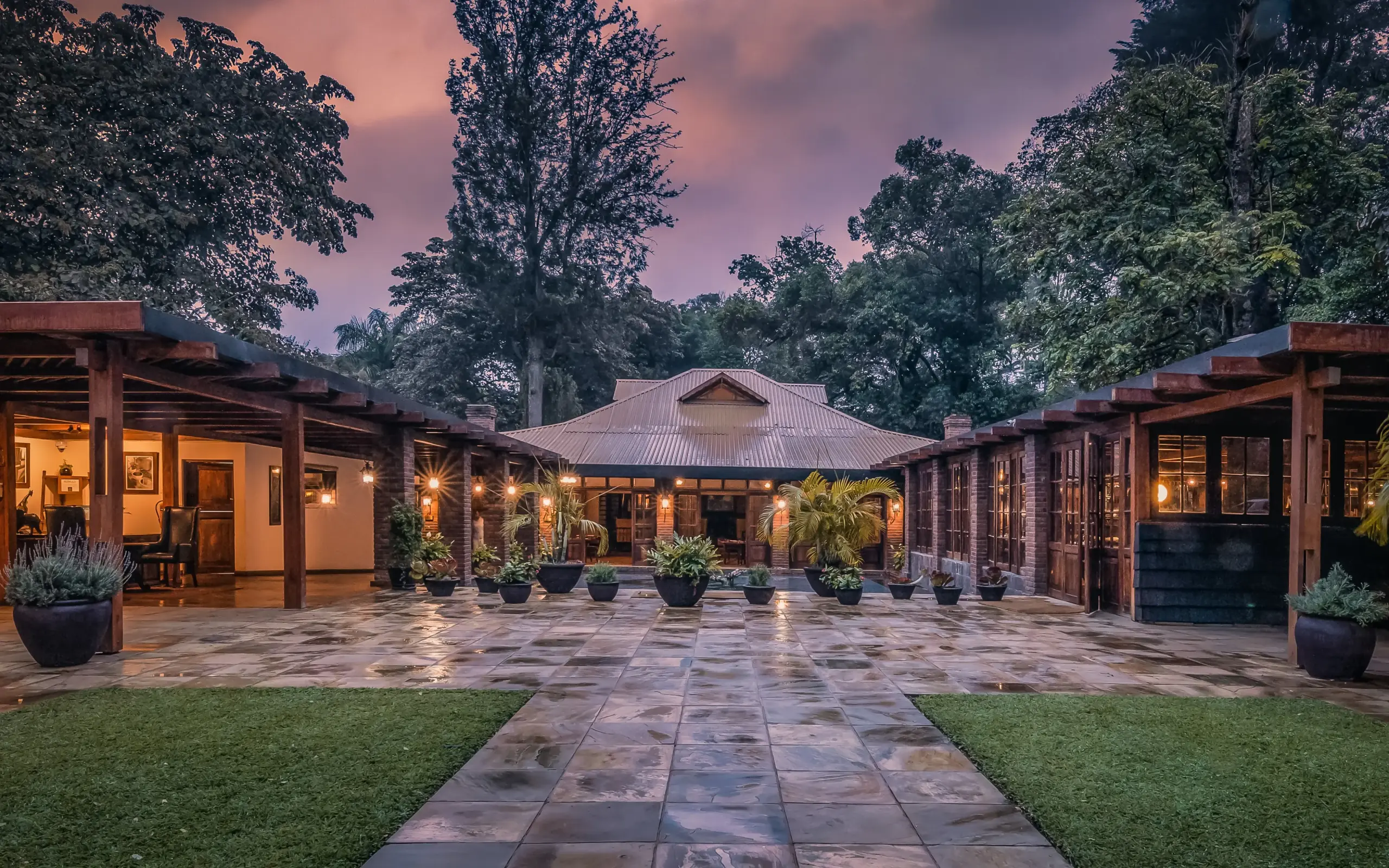 Courtyard lodge with illuminated colonial-style buildings at dusk, Arusha Coffee Lodge, Arusha, Tanzania