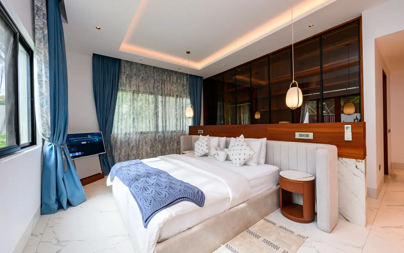 Modern bedroom suite with wood-paneled wall and pendant lighting, Bahari Bliss, Kilifi, Kenya