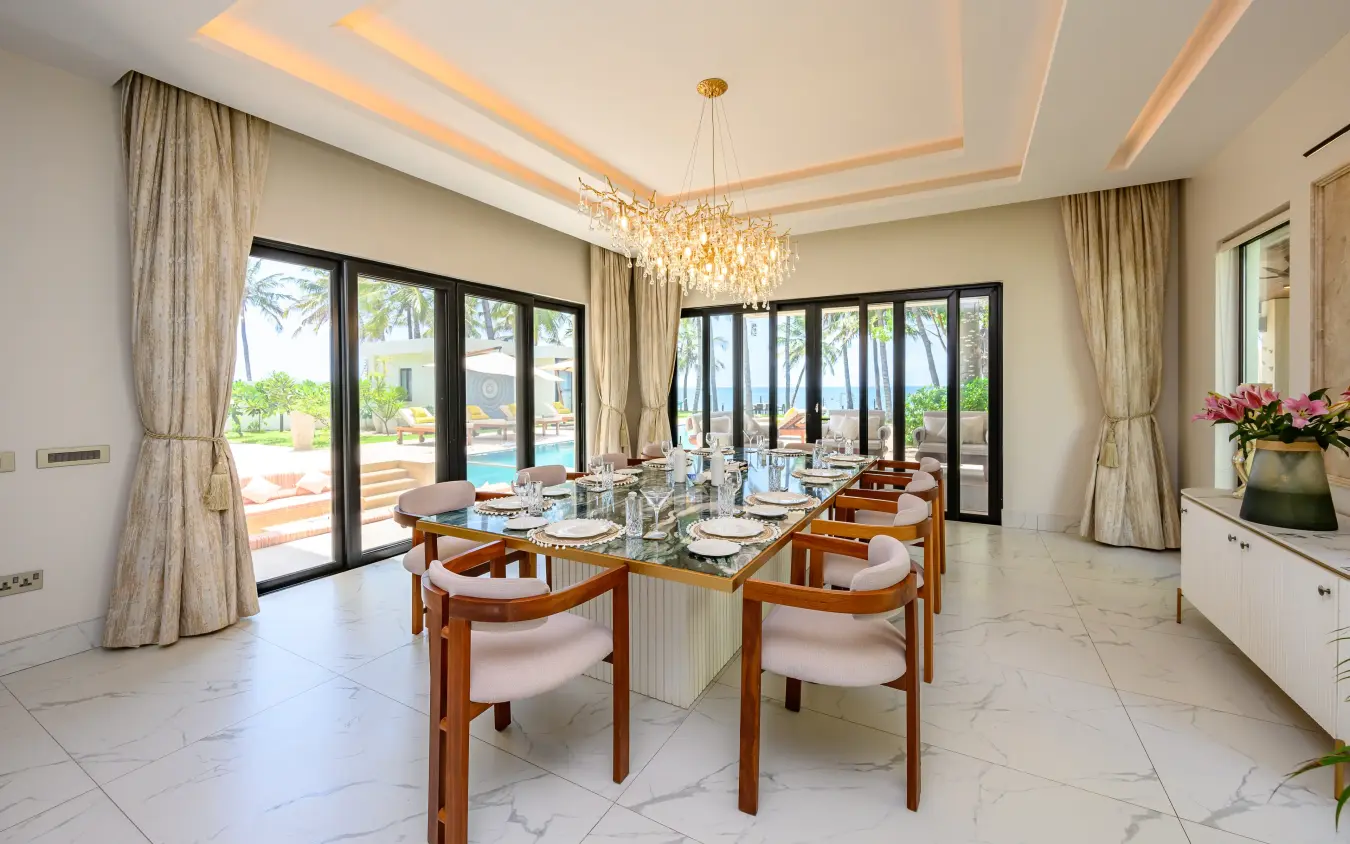 Dining room with glass doors overlooking poolside terrace and landscape, Bahari Bliss, Kilifi, Kenya