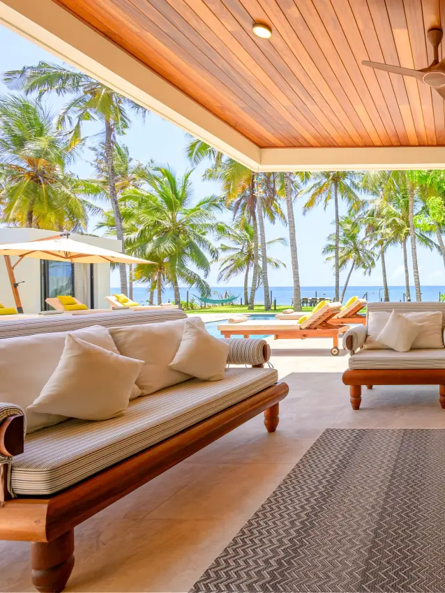 Beachfront pavilion with wooden loungers overlooking tropical coastline, Bahari Bliss, Kilifi, Kenya