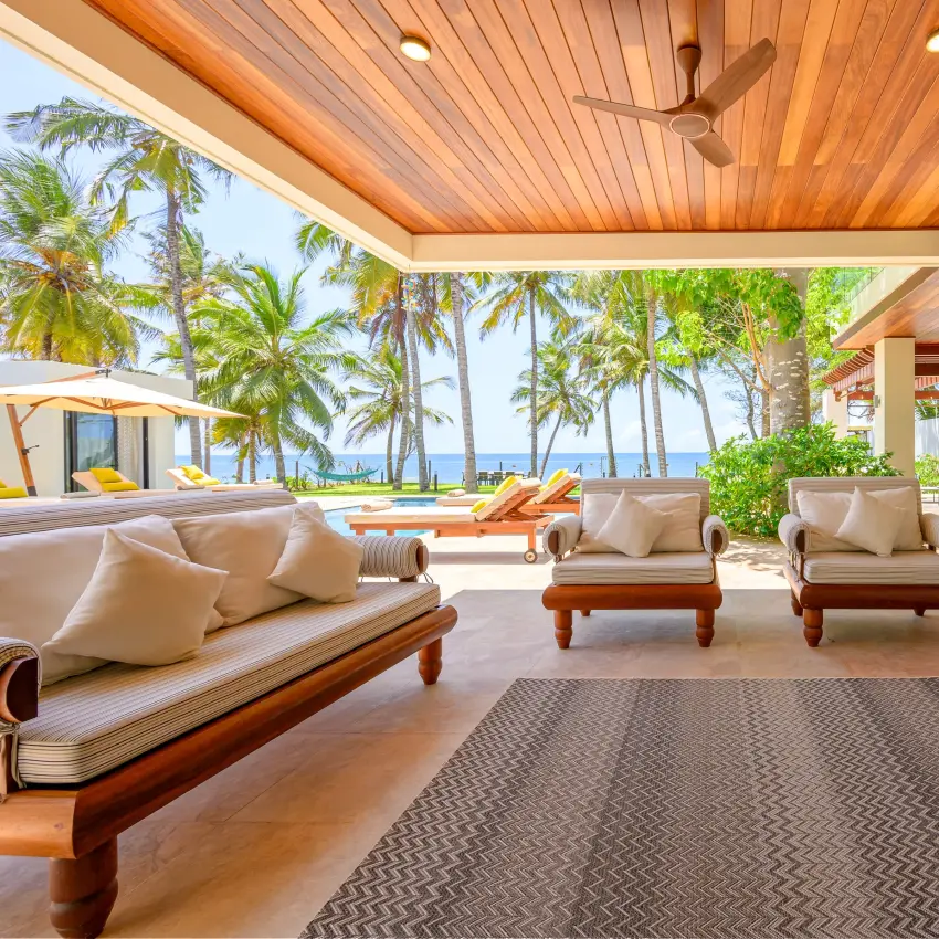 Beachfront pavilion with wooden loungers overlooking tropical coastline, Bahari Bliss, Kilifi, Kenya