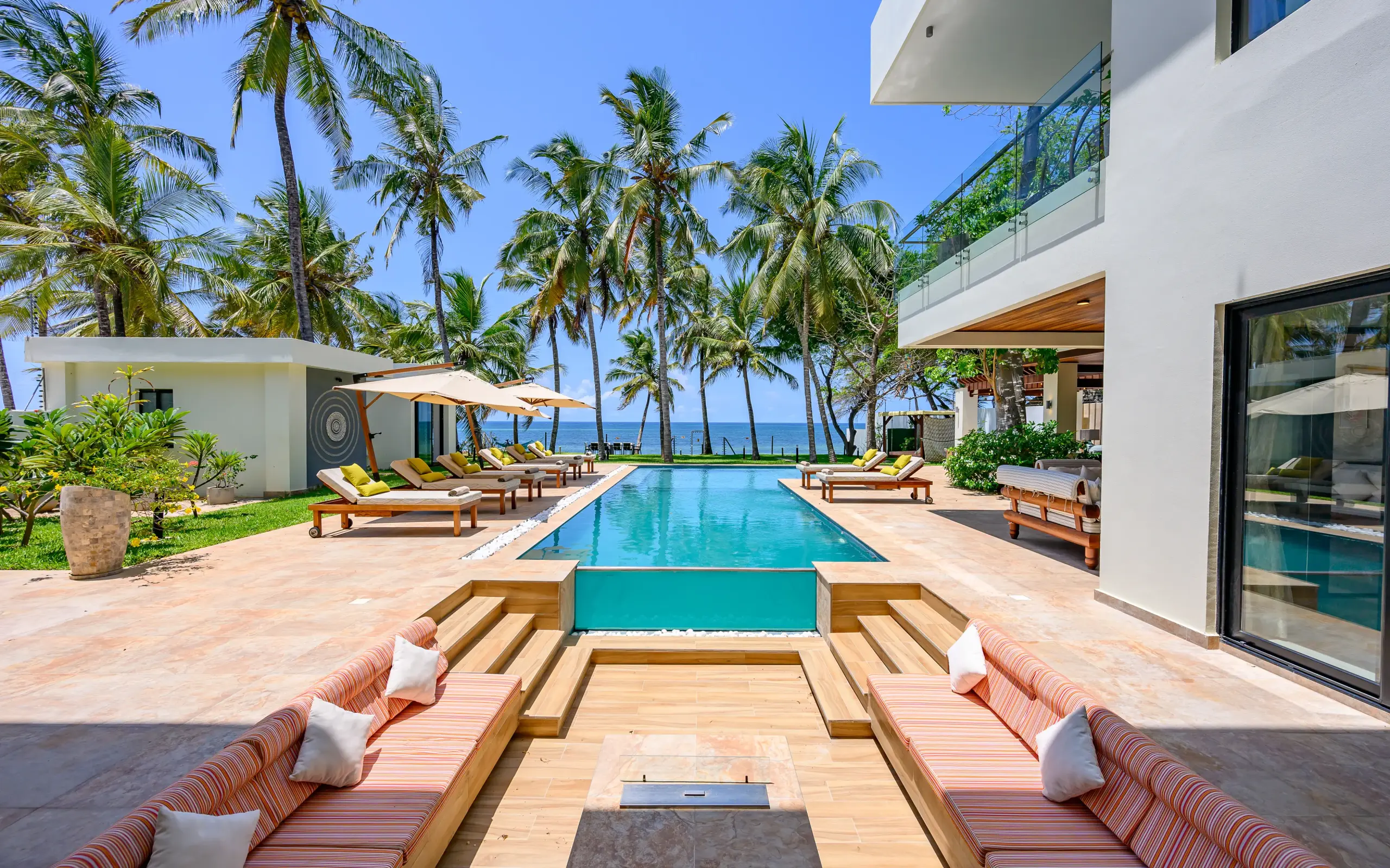 Modern beachfront villa with infinity pool overlooking ocean and palm trees, Bahari Bliss, Kilifi, Kenya