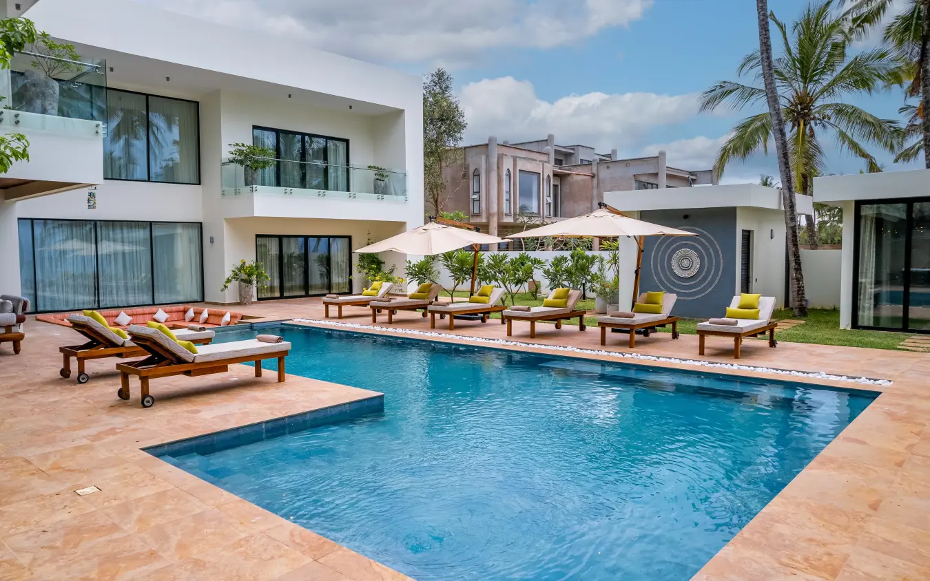 Modern villa with swimming pool and loungers in tropical garden setting, Bahari Bliss, Kilifi, Kenya