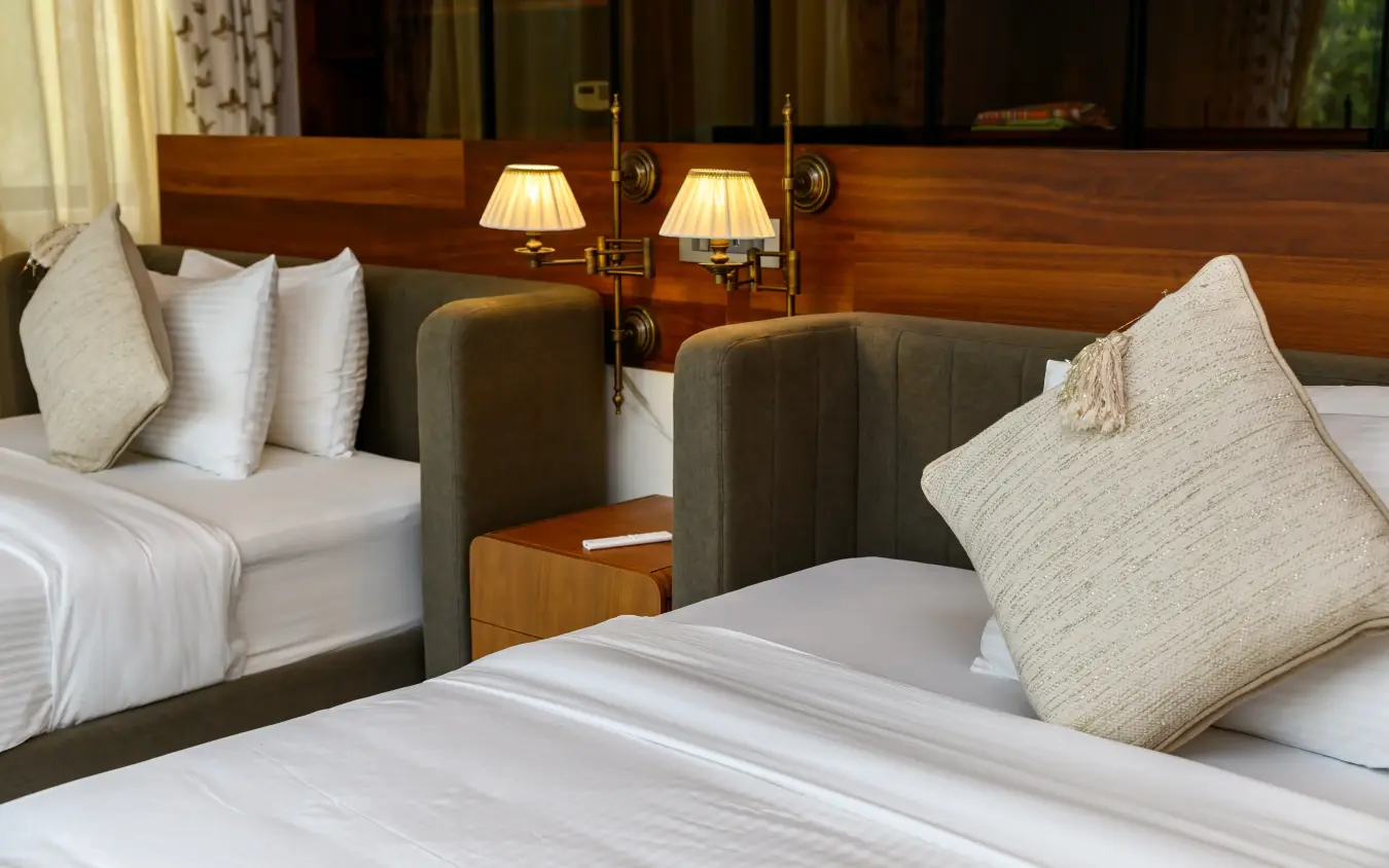 Luxury hotel bedroom with twin beds and wooden headboard detail, Bahari Bliss, Kilifi, Kenya