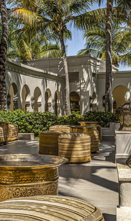 Courtyard with ornate brass vessels and palm trees, Baraza Resort and Spa, Zanzibar & Pemba, Tanzania
