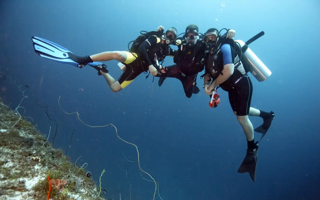 Scuba divers exploring coral reef underwater formation, Baraza Resort and Spa, Zanzibar & Pemba, Tanzania