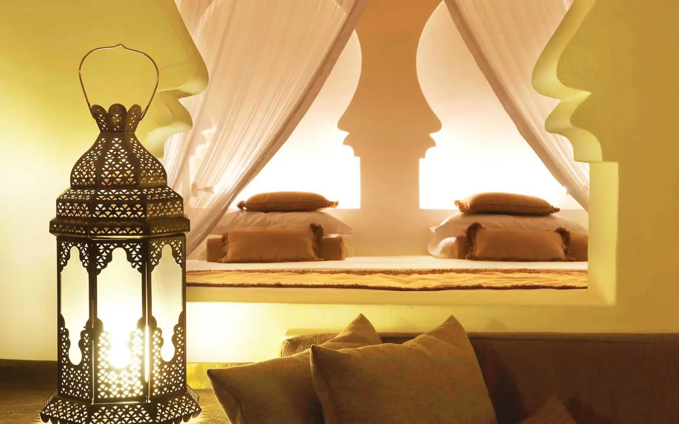 Luxurious bedroom with ornate lantern and carved headboard, Baraza Resort and Spa, Zanzibar & Pemba, Tanzania