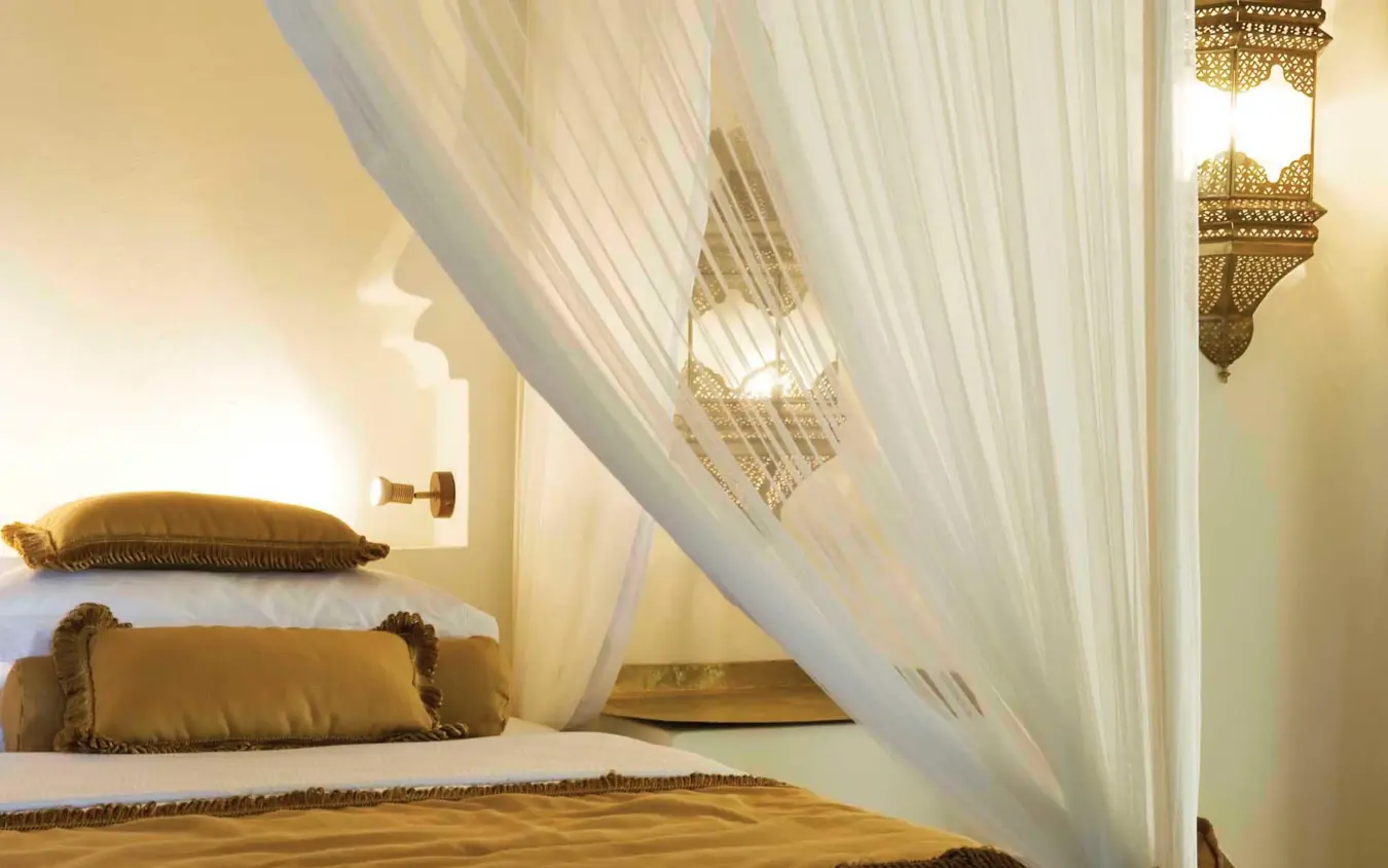 Bedroom with sheer canopy drapes and gold accents, Baraza Resort and Spa, Zanzibar & Pemba, Tanzania