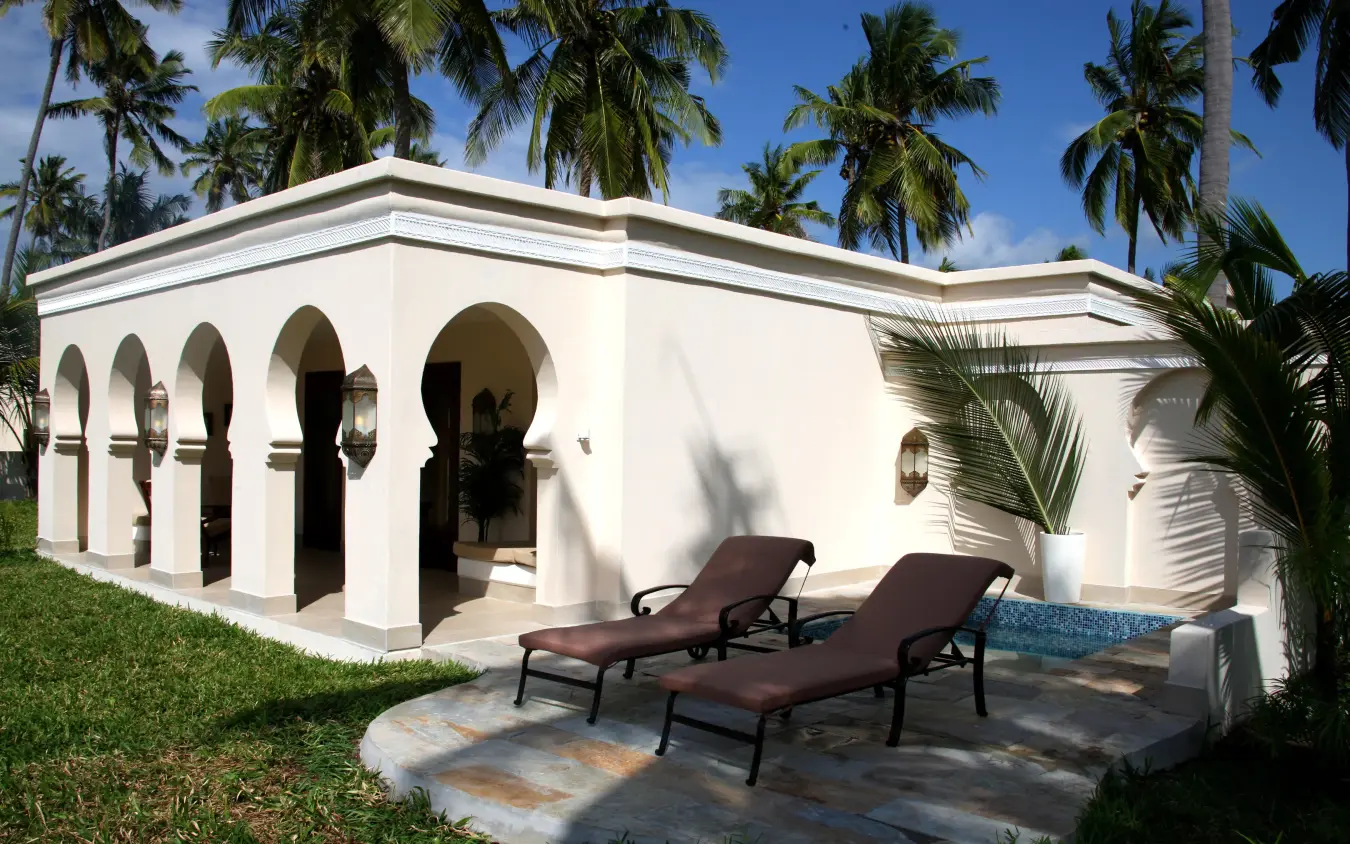 White arched pavilion with loungers and palm trees, Baraza Resort and Spa, Zanzibar & Pemba, Tanzania