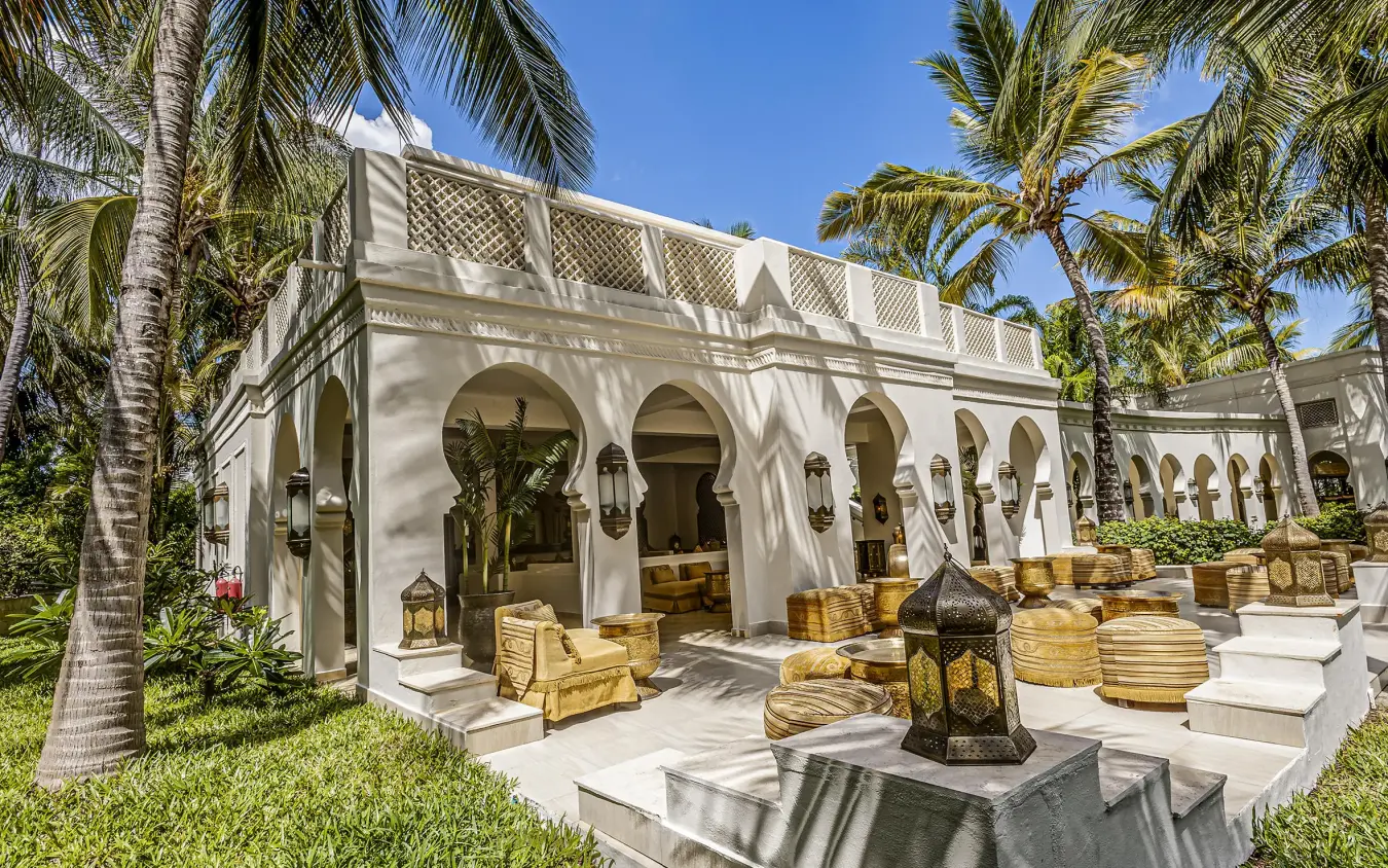 White Moroccan-style building with arched colonnade and palm trees, Baraza Resort and Spa, Zanzibar & Pemba, Tanzania
