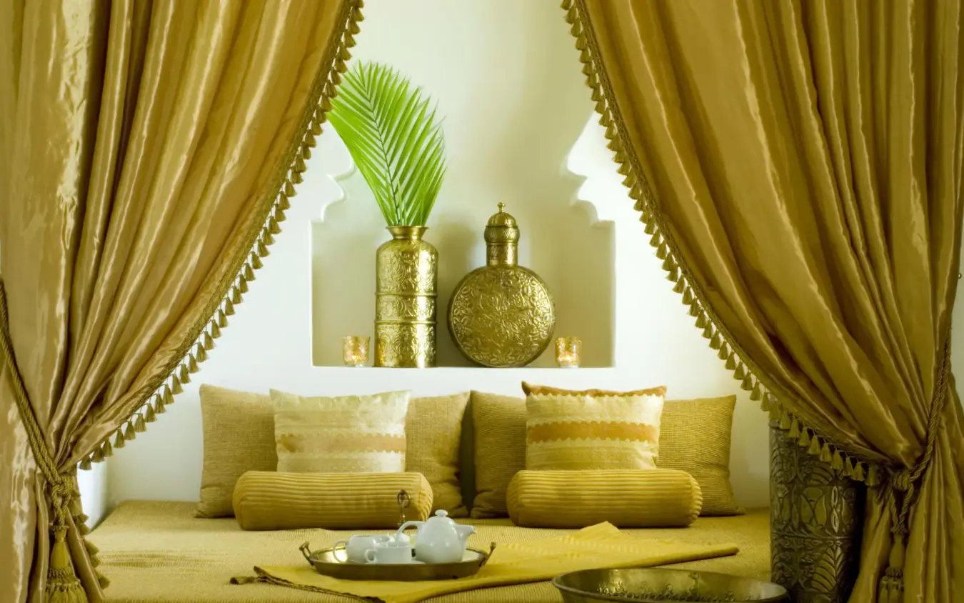 Gold-toned seating alcove with draped curtains and decorative objects, Baraza Resort and Spa, Zanzibar & Pemba, Tanzania