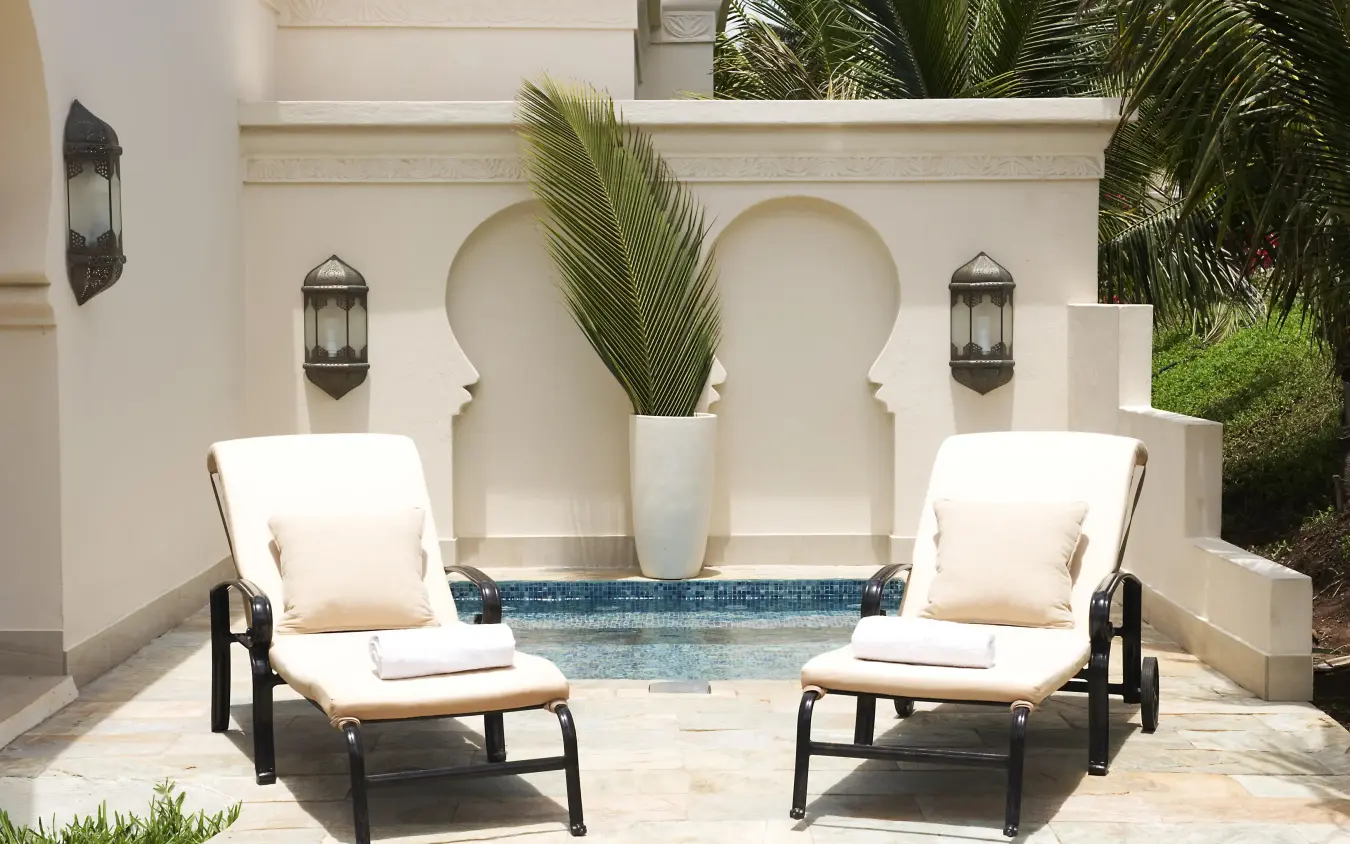 Symmetrical courtyard seating area with decorative arches and plants, Baraza Resort and Spa, Zanzibar & Pemba, Tanzania