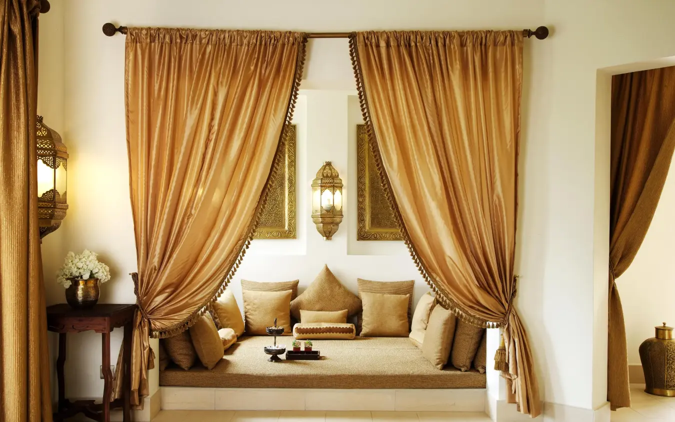Luxurious bedroom lounge with draped curtains and cushioned seating, Baraza Resort and Spa, Zanzibar & Pemba, Tanzania