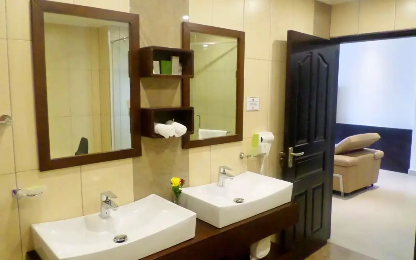 Dual sink vanity with mirrors and shelving in bathroom, Best Western Premier Garden Hotel Entebbe, Entebbe and Kampala, Uganda