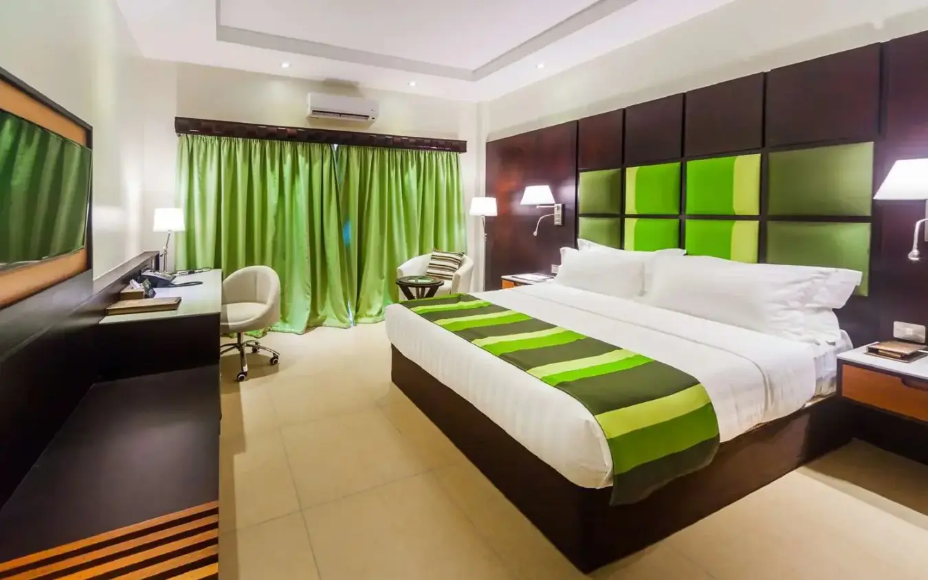 Modern hotel bedroom with green accents and desk workspace, Best Western Premier Garden Hotel Entebbe, Entebbe and Kampala, Uganda
