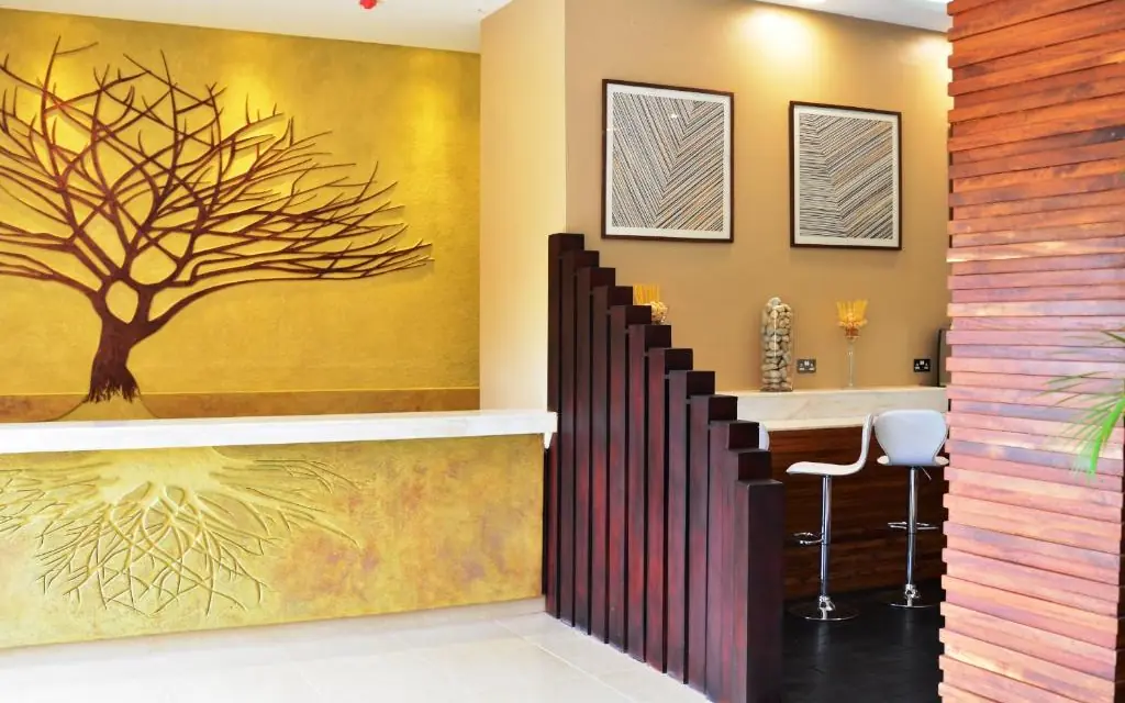 Modern reception area with golden tree mural artwork, Best Western Premier Garden Hotel Entebbe, Entebbe and Kampala, Uganda