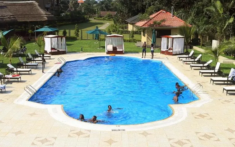 Resort swimming pool with lounge chairs and tropical grounds, Best Western Premier Garden Hotel Entebbe, Entebbe and Kampala, Uganda