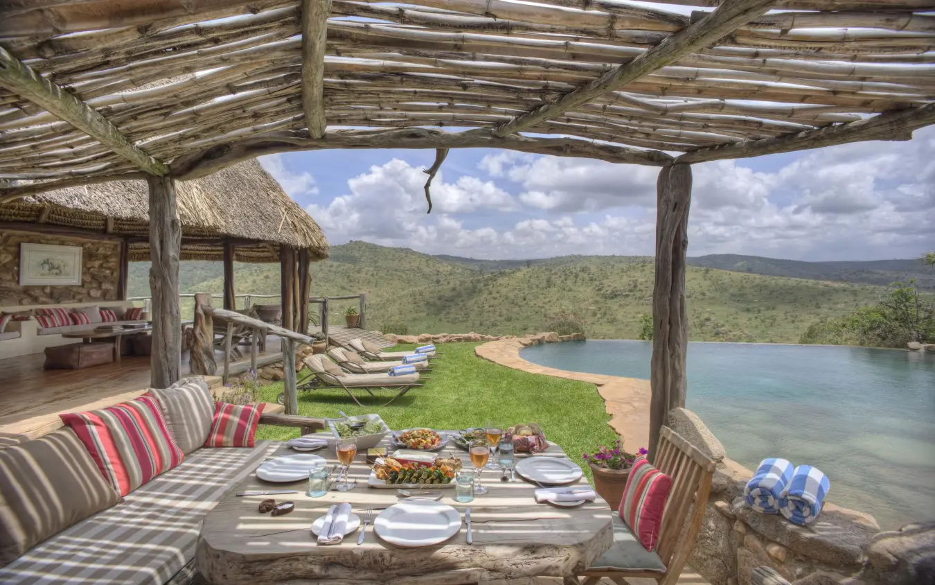 Lakeside dining pavilion overlooking water and savanna hills, Borana Lodge, Laikipia Highlands, Kenya