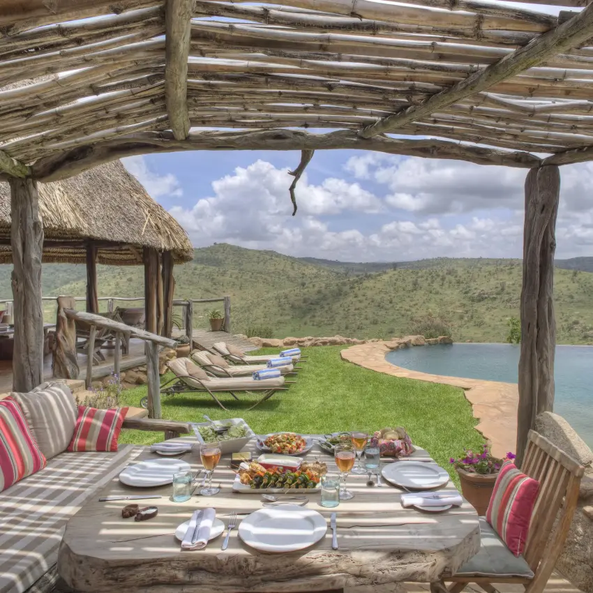 Lakeside dining pavilion overlooking water and savanna hills, Borana Lodge, Laikipia Highlands, Kenya