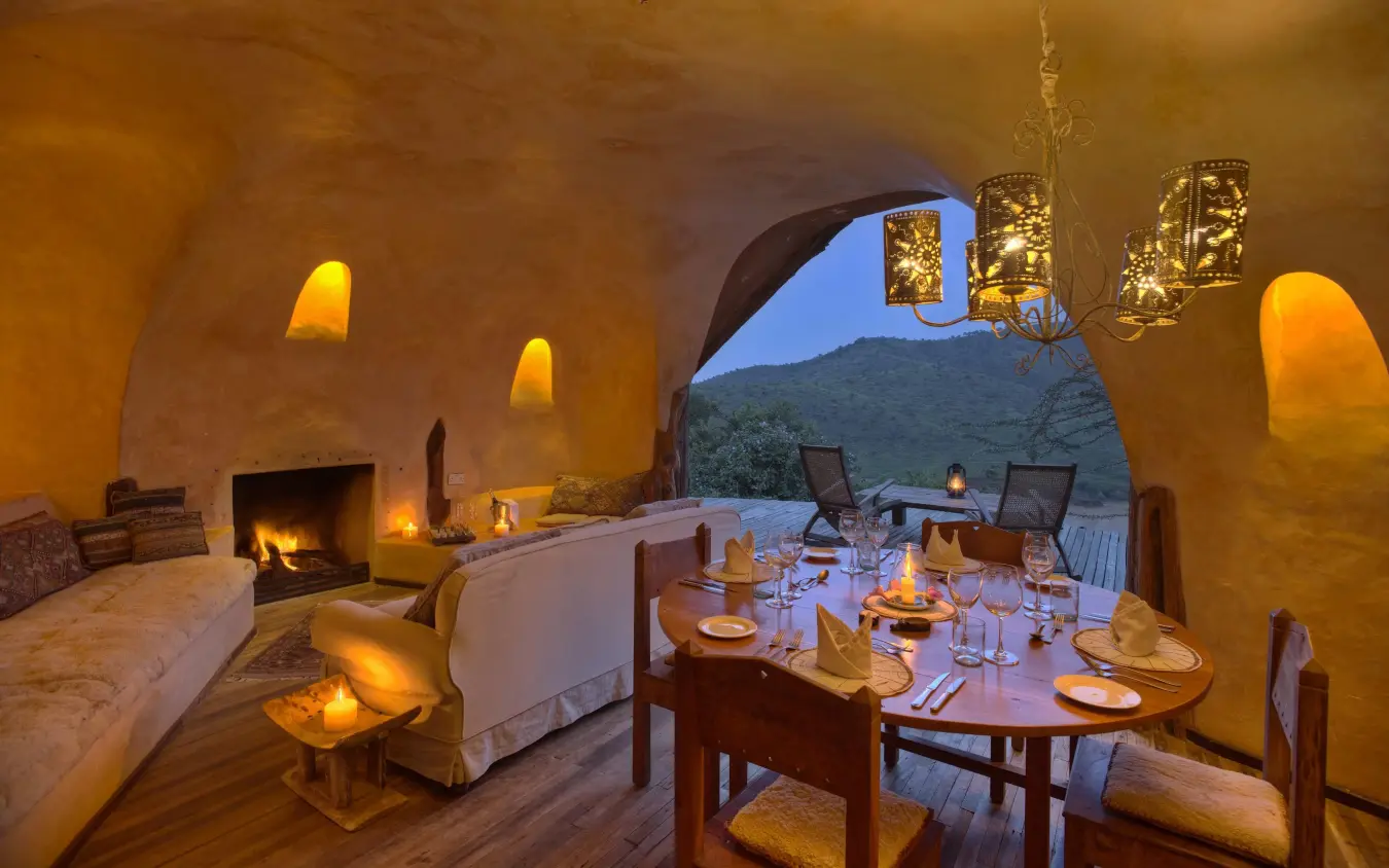 Candlelit dining room with mountain view at dusk, Borana Lodge, Laikipia Highlands, Kenya