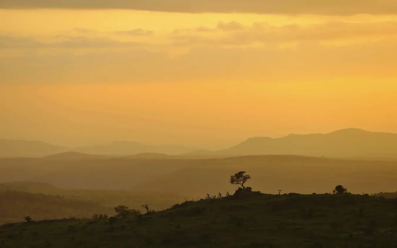 Golden sunset over layered mountains and savanna hills, Borana Lodge, Laikipia Highlands, Kenya