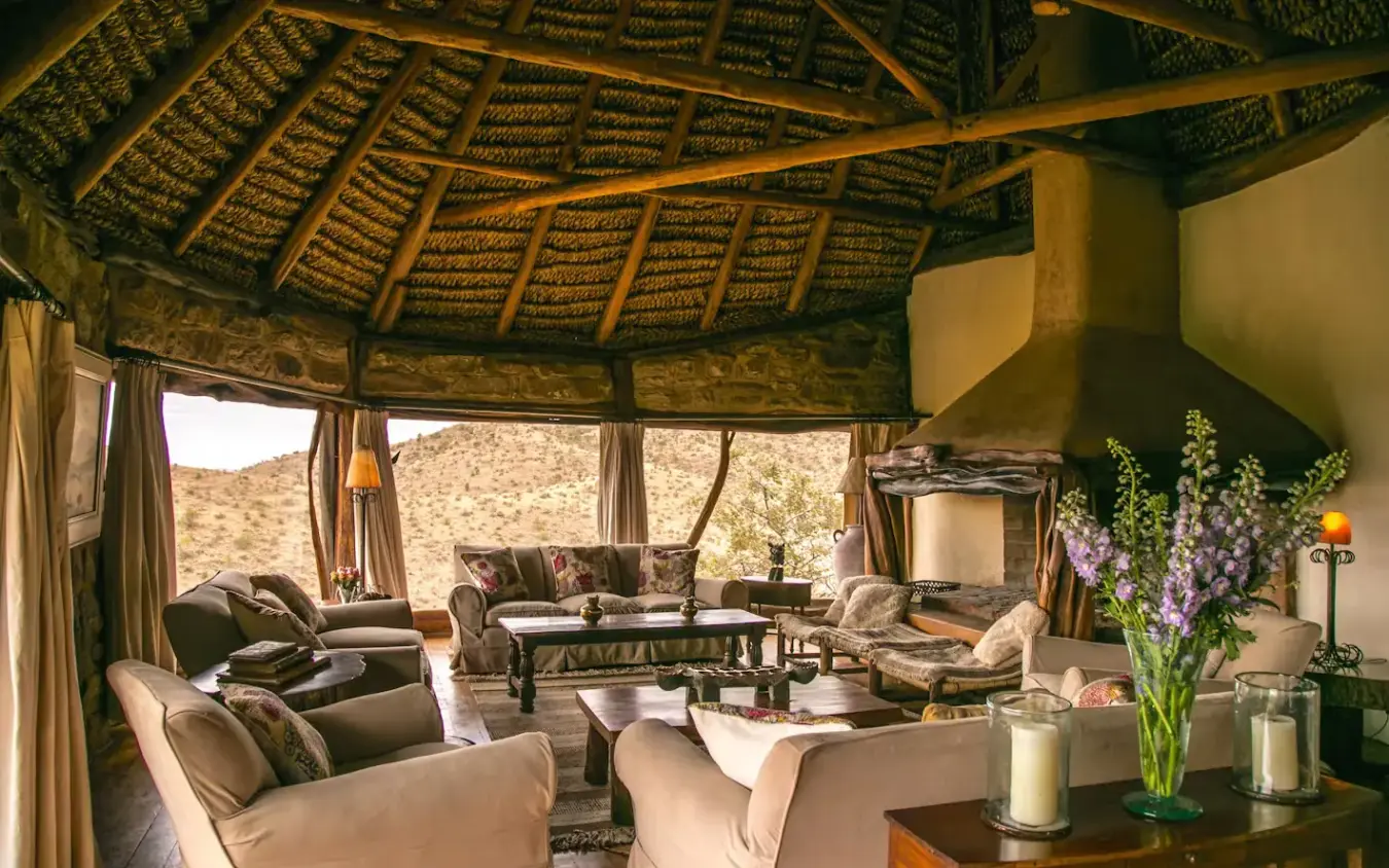 Open-air lounge with thatched roof and desert views, Borana Lodge, Laikipia Highlands, Kenya