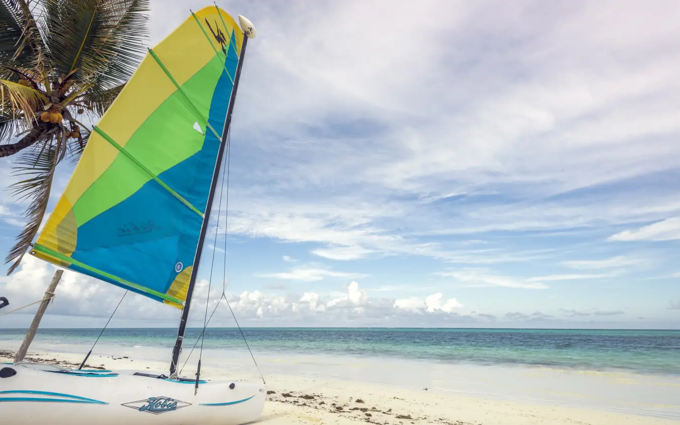 Colorful sailboat with outrigger on tropical beach at sunset, Breezes Beach Club & Spa, Zanzibar & Pemba, Tanzania
