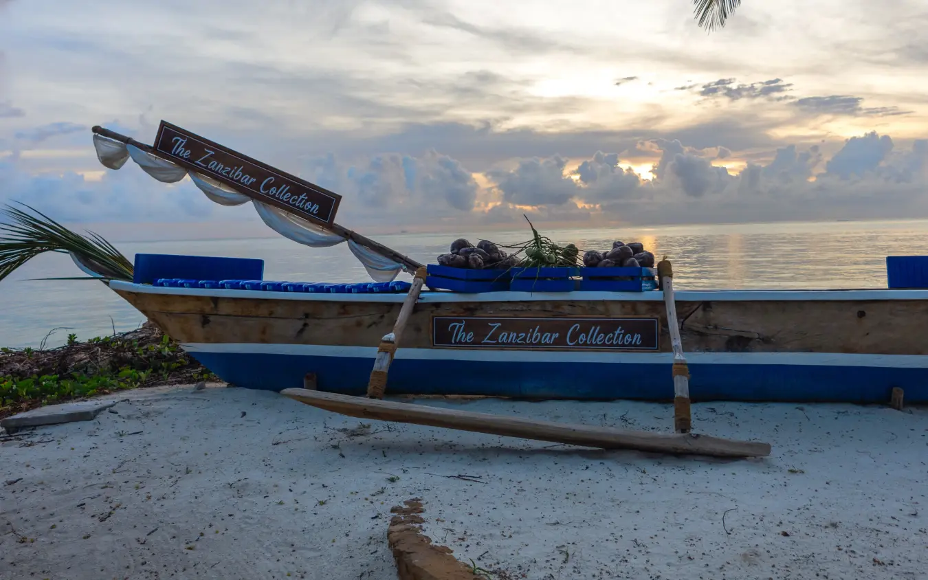 Traditional wooden dhow beached on white sand at sunset, Breezes Beach Club & Spa, Zanzibar & Pemba, Tanzania