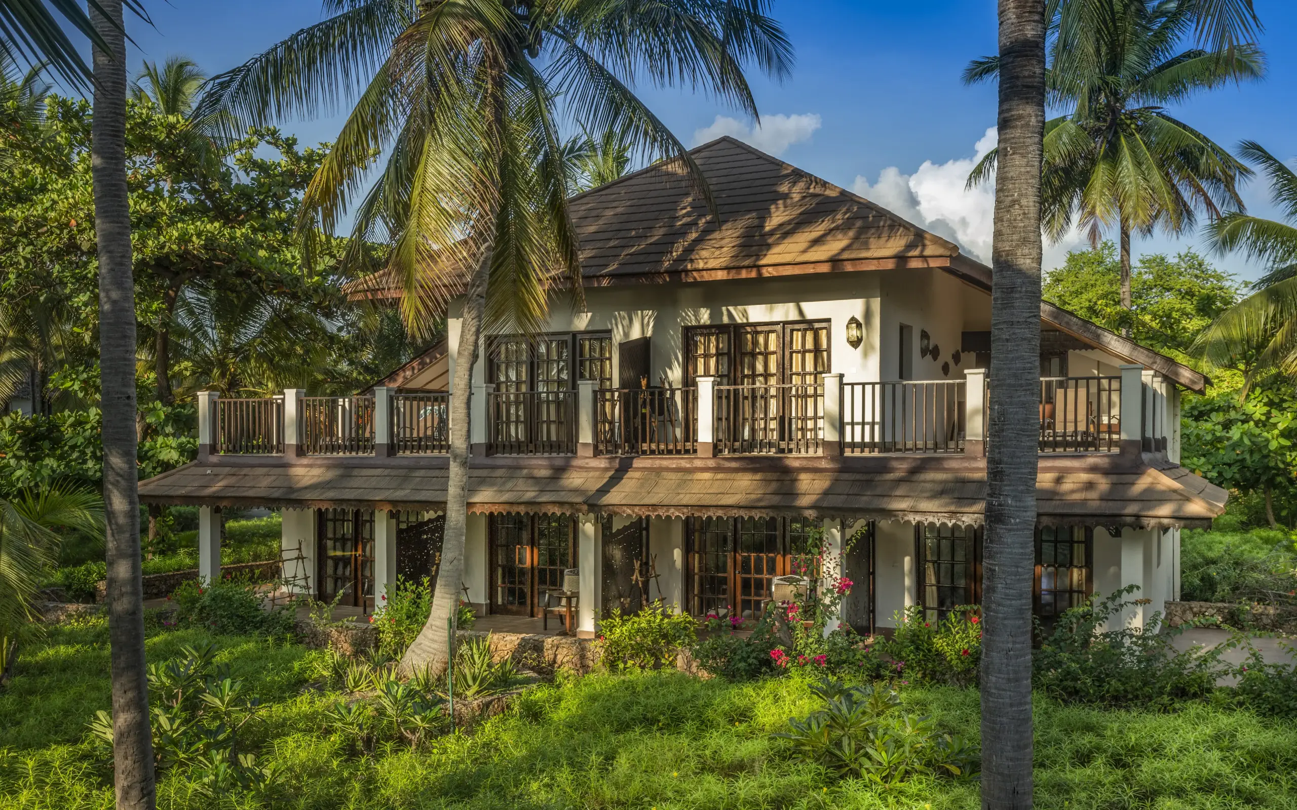 Elevated colonial-style lodge surrounded by palm trees and tropical vegetation, Breezes Beach Club & Spa, Zanzibar & Pemba, Tanzania
