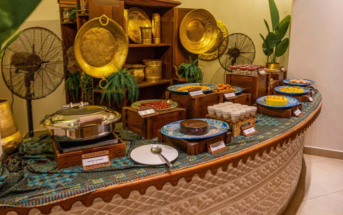 Decorative display of brass plates and traditional tableware on patterned counter, Breezes Beach Club & Spa, Zanzibar & Pemba, Tanzania