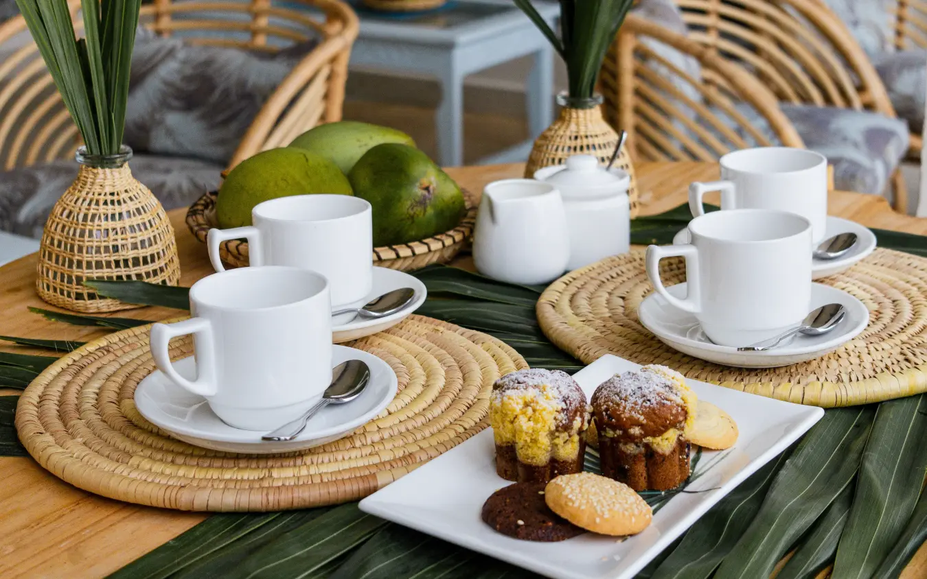 Outdoor tea service with pastries on woven placemats and palm leaves, Breezes Beach Club & Spa, Zanzibar & Pemba, Tanzania