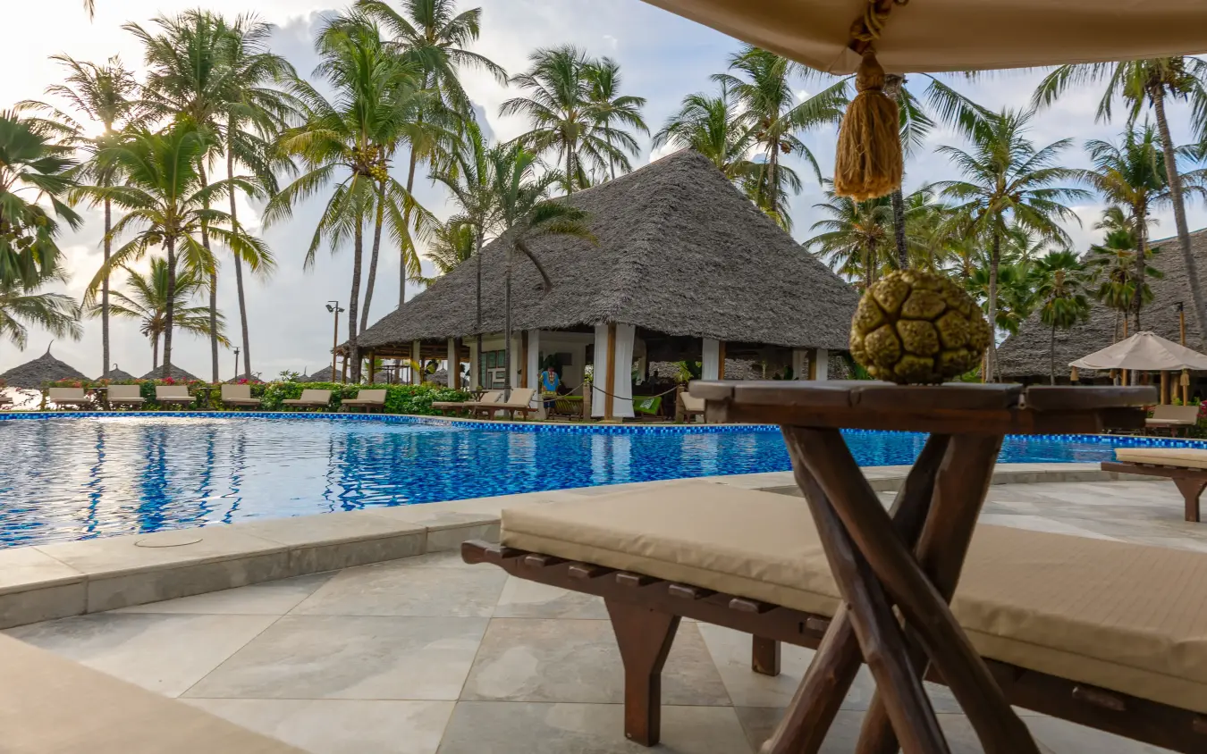 Beachfront resort pool with thatched-roof bar and palm trees, Breezes Beach Club & Spa, Zanzibar & Pemba, Tanzania