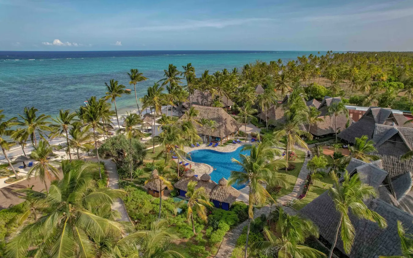 Aerial view of beachfront resort with pool surrounded by palm trees and ocean, Breezes Beach Club & Spa, Zanzibar & Pemba, Tanzania
