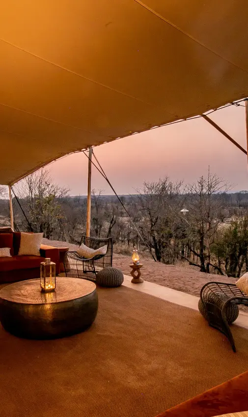 Luxury safari lounge with panoramic savanna views at dusk, Camp Chitubu, Hwange National Park, Zimbabwe