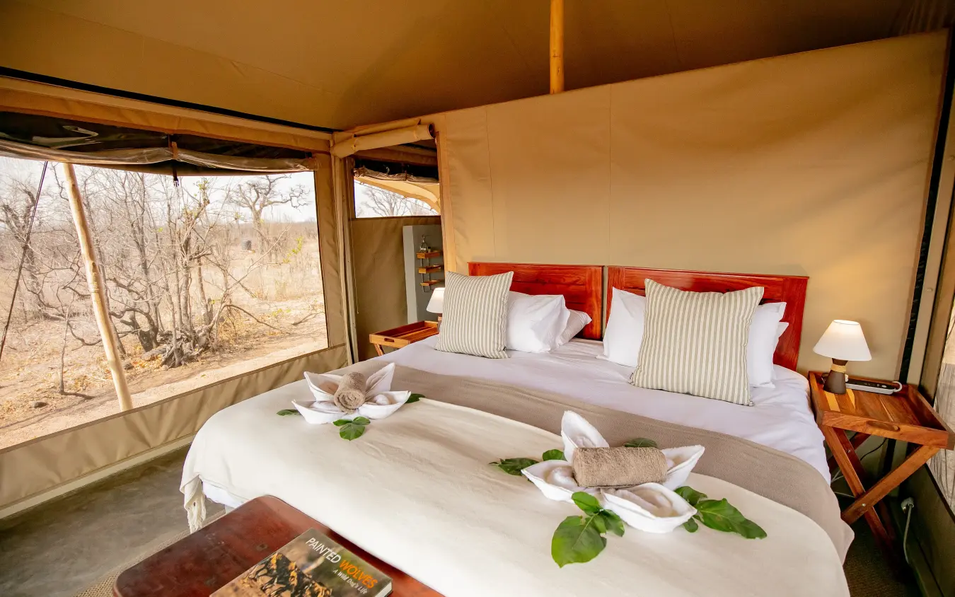 Luxury safari tent bedroom with canvas walls and savanna view, Camp Chitubu, Hwange National Park, Zimbabwe