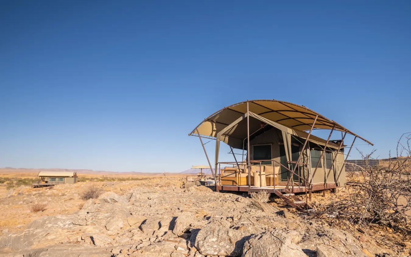 Glamping tent with extended canvas canopy in desert landscape, Camp Doros, Damaraland, Namibia