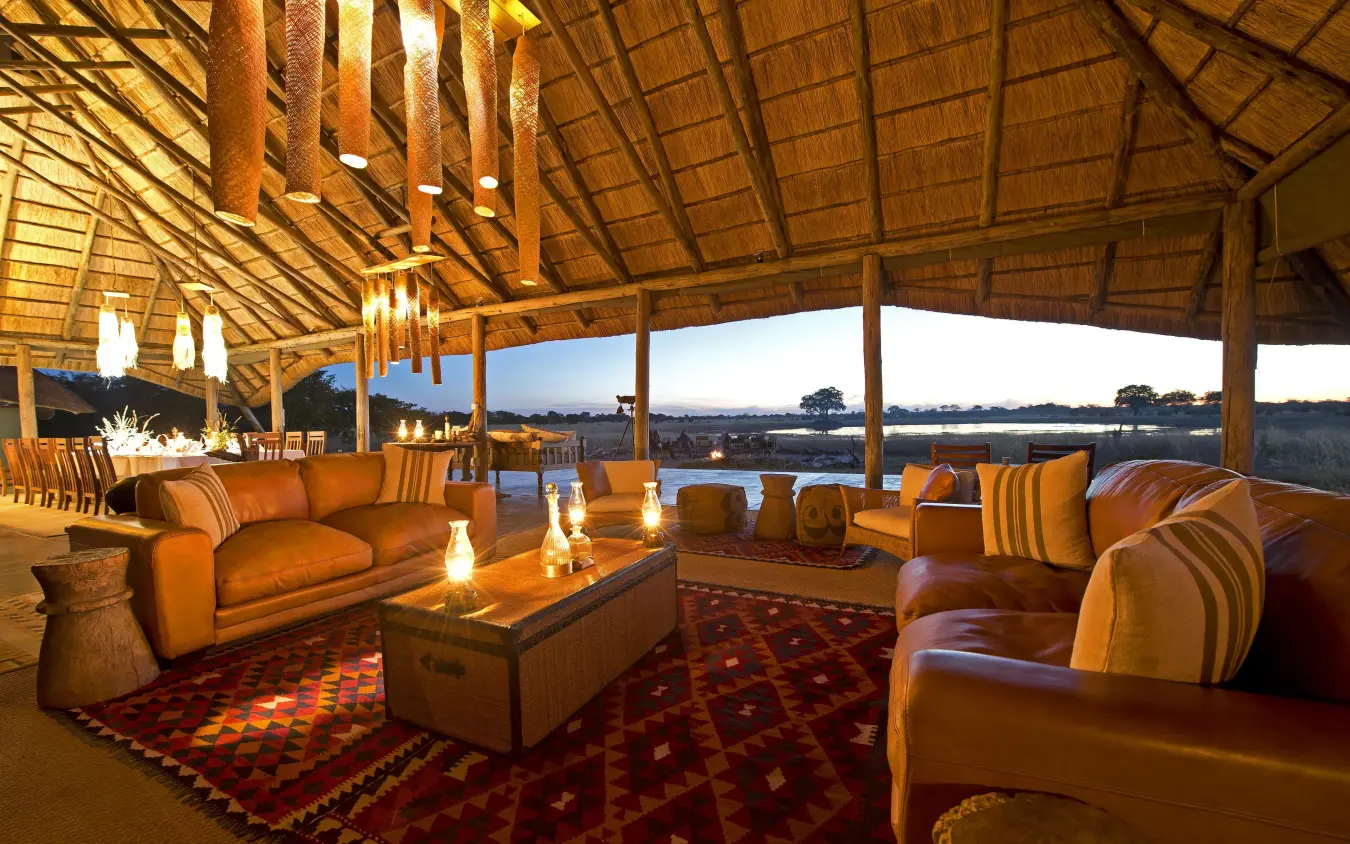 Open-air lounge with leather seating and savanna views, Camp Hwange, Hwange National Park, Zimbabwe
