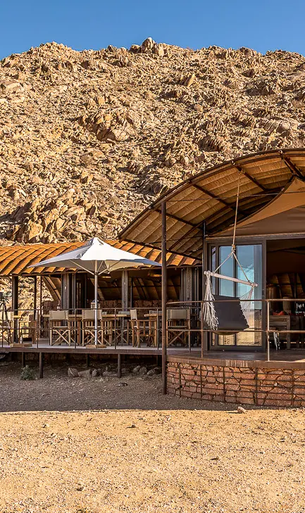 Desert lodge accommodation with curved roof and terrace, Camp Sossus, Sossusvlei, Namibia