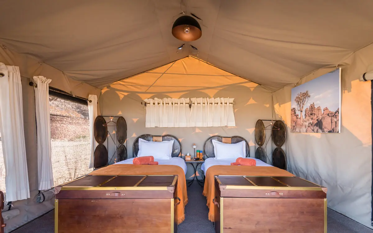 Twin beds in canvas safari tent with cream interior, Camp Sossus, Sossusvlei, Namibia