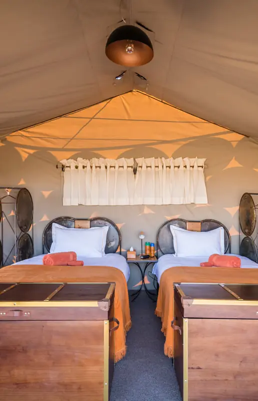 Twin beds in canvas safari tent with cream interior, Camp Sossus, Sossusvlei, Namibia