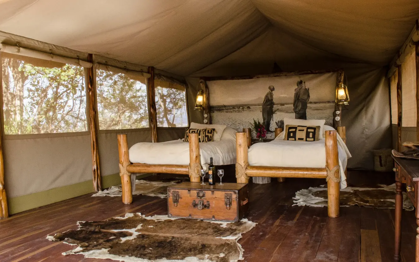 Luxury safari tent interior with two beds and canvas walls, Campi ya Kanzi, Amboseli and Chyulu Hills, Kenya