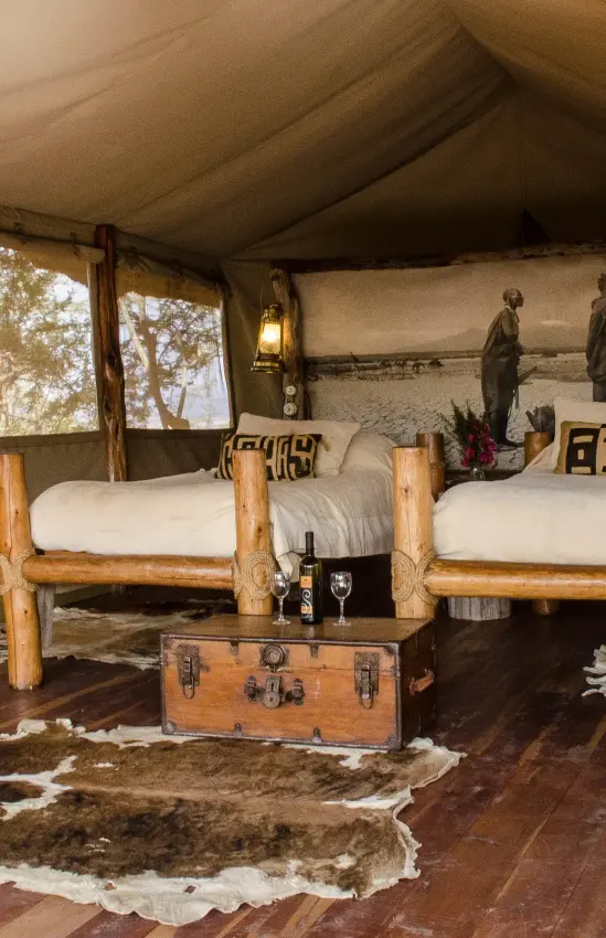 Luxury safari tent interior with two beds and canvas walls, Campi ya Kanzi, Amboseli and Chyulu Hills, Kenya