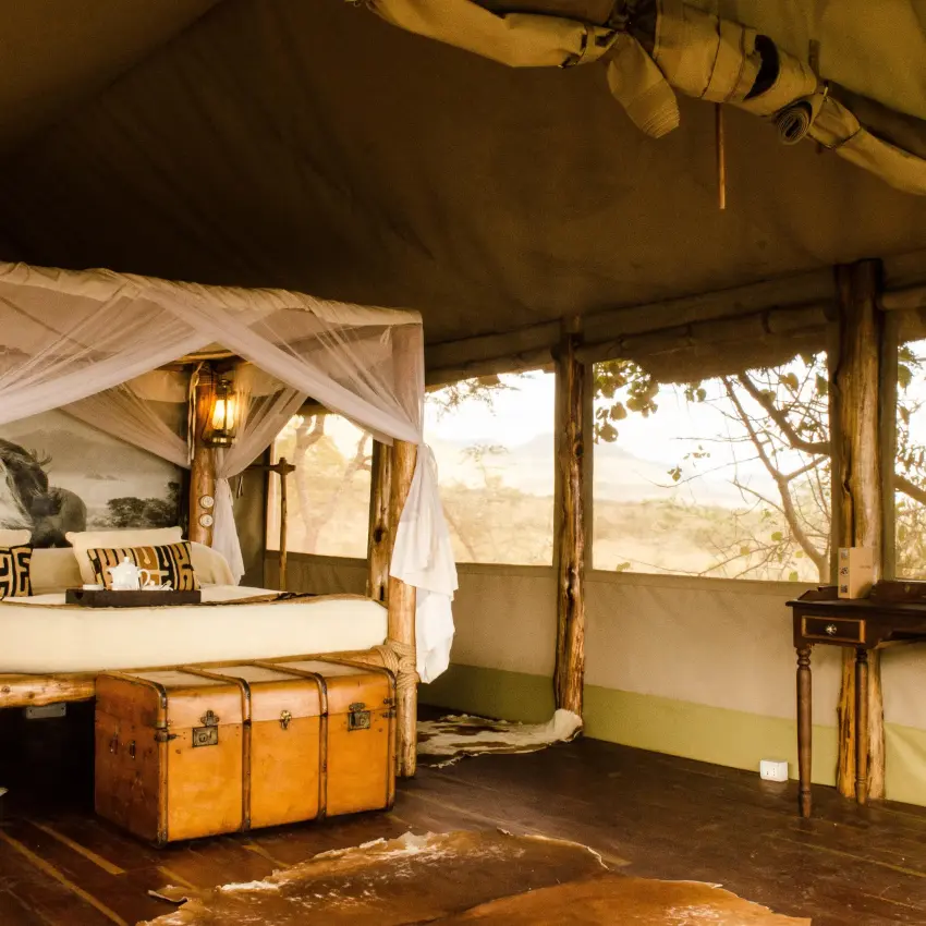 Safari tent bedroom with four-poster bed and canvas drapes, Campi ya Kanzi, Amboseli and Chyulu Hills, Kenya