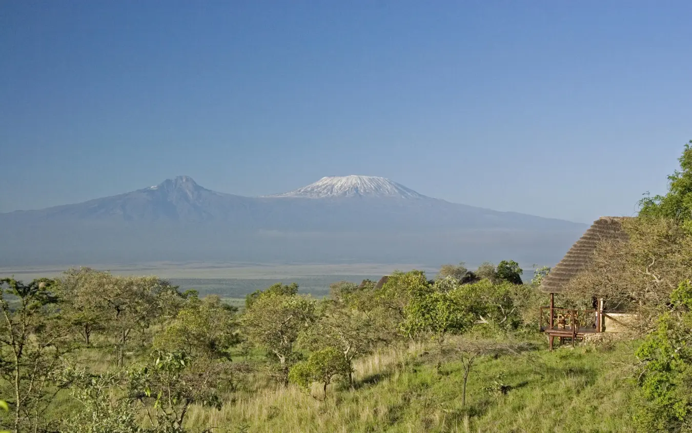 Snow-capped mountain rising above acacia woodland savanna, Campi ya Kanzi, Amboseli and Chyulu Hills, Kenya