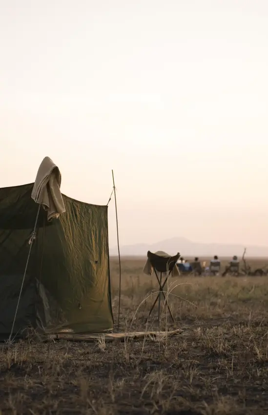 Canvas shelter set up in vast African savanna at dusk, Chada Camp, Katavi National Park, Tanzania