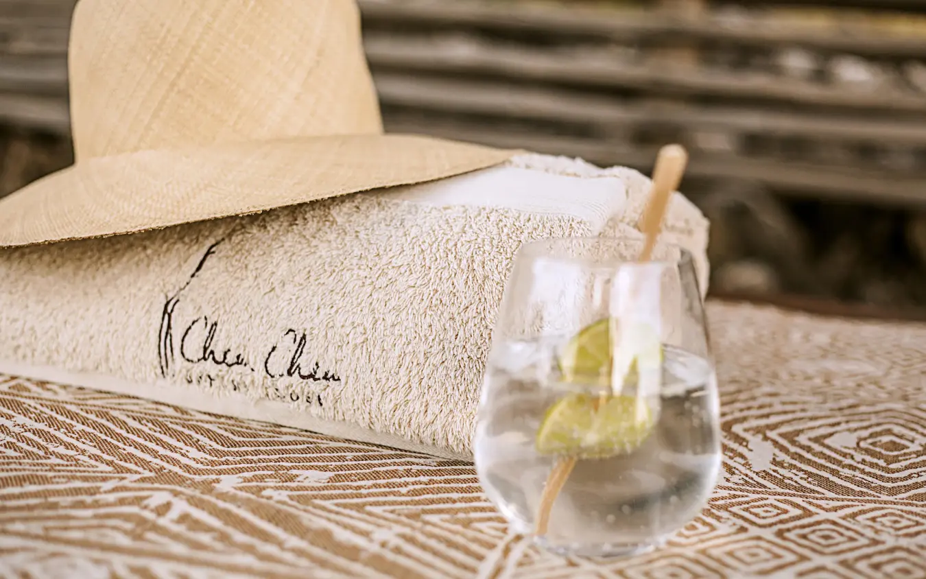 Embroidered towel, straw hat, and refreshment glass, Chem Chem Lodge, Lake Manyara, Tanzania