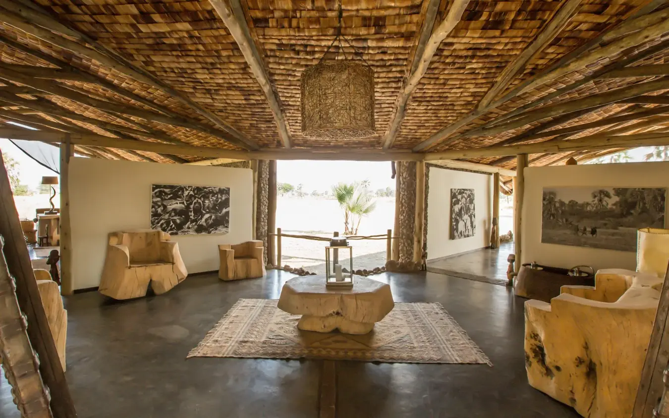 Open-air lounge with wooden furniture and woven ceiling, Chem Chem Lodge, Lake Manyara, Tanzania