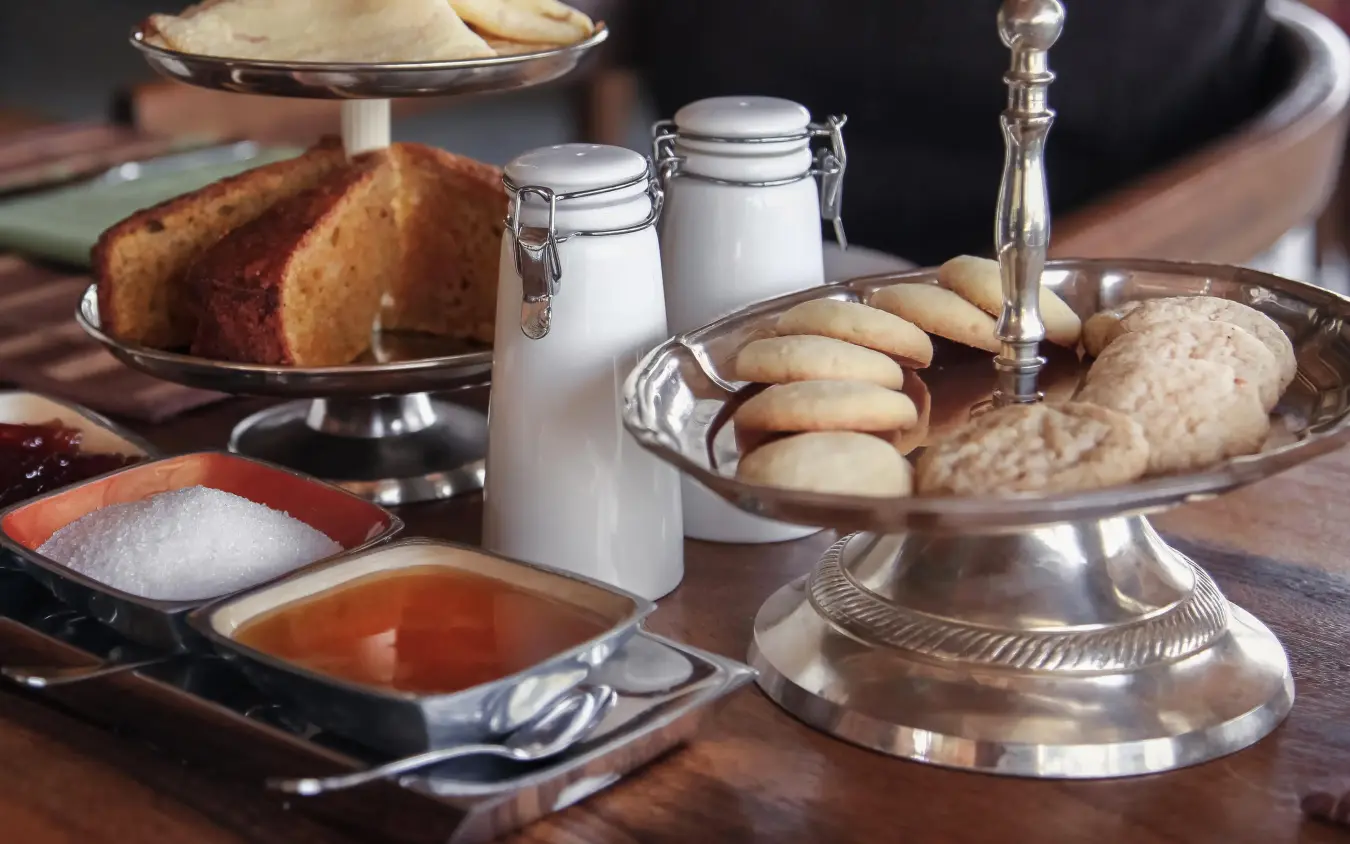 Table setting with cakes, cookies, beverages and condiments, Chem Chem Lodge, Lake Manyara, Tanzania