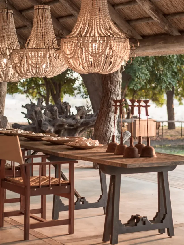 Covered dining pavilion with beaded chandeliers and wooden tables, Chikwenya Camp, Mana Pools, Zimbabwe